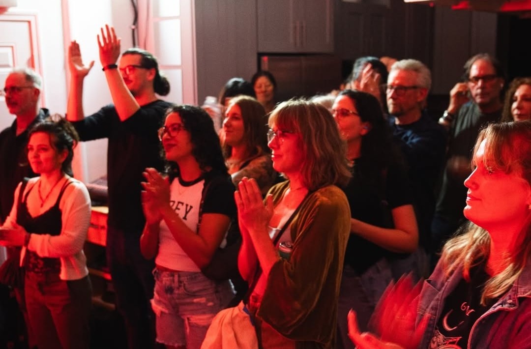 A crowd cheering at a live night in The Session Room